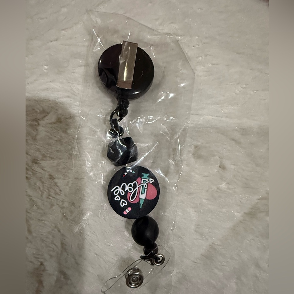 Black Badge Reel with Heart Design